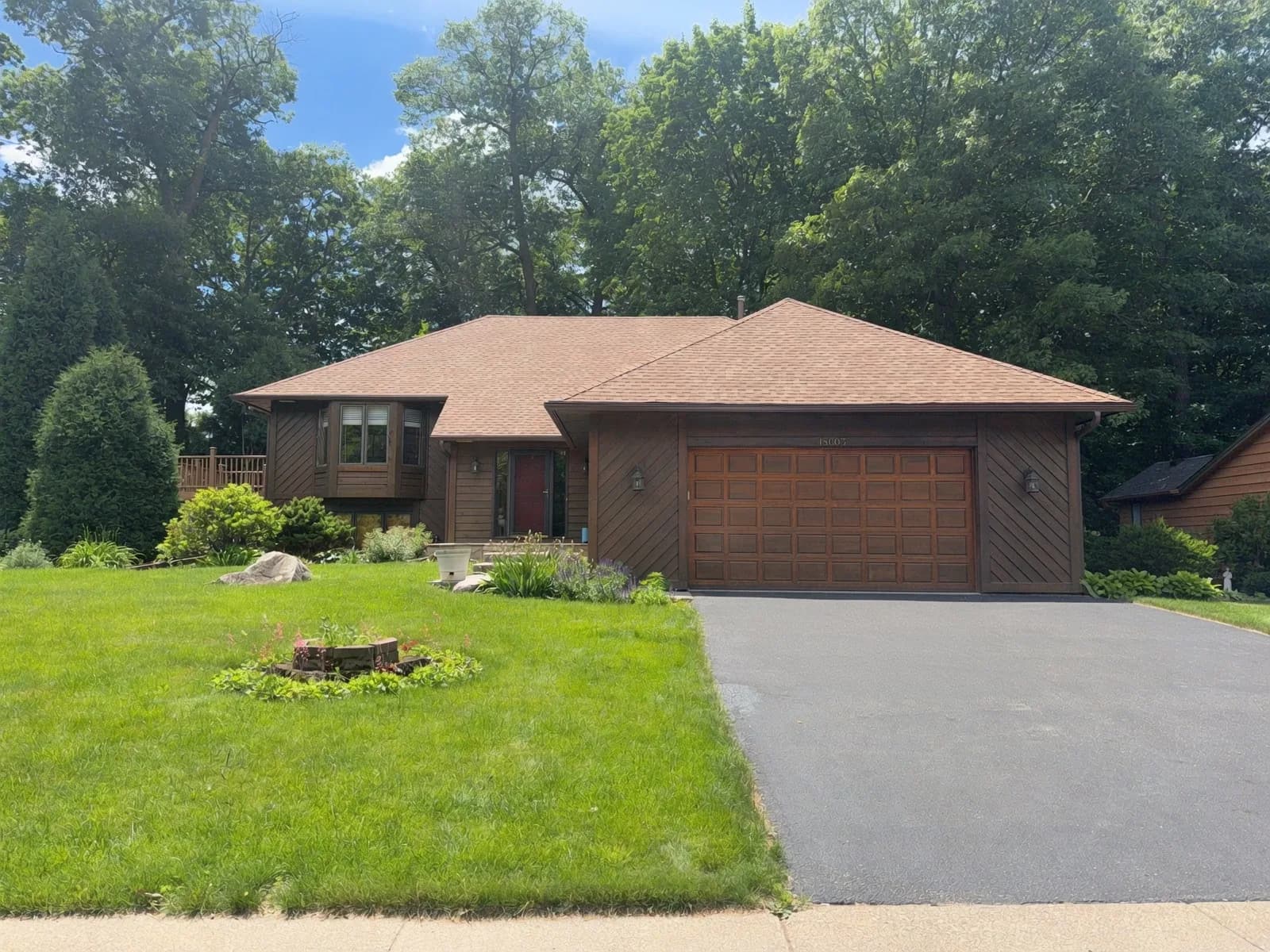 Twin Cities split-level with original 1980s dark diagonal cedar siding, before redesign