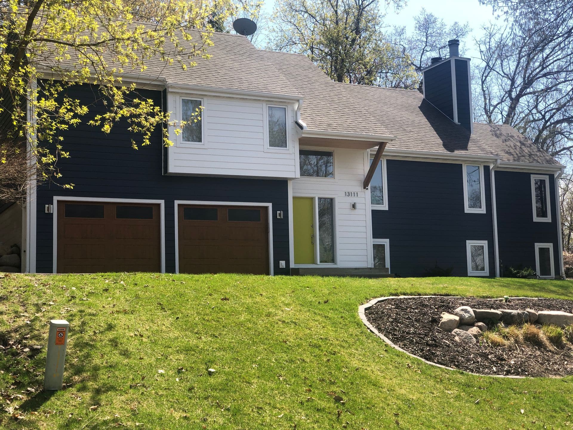 Deep navy LP SmartSide siding with white trim on a Twin Cities two-story — installed by Modern Exterior Systems